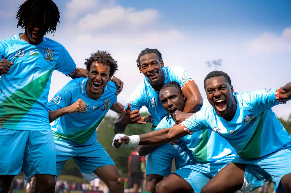 Players celebrating a tournament victory under bright spotlights