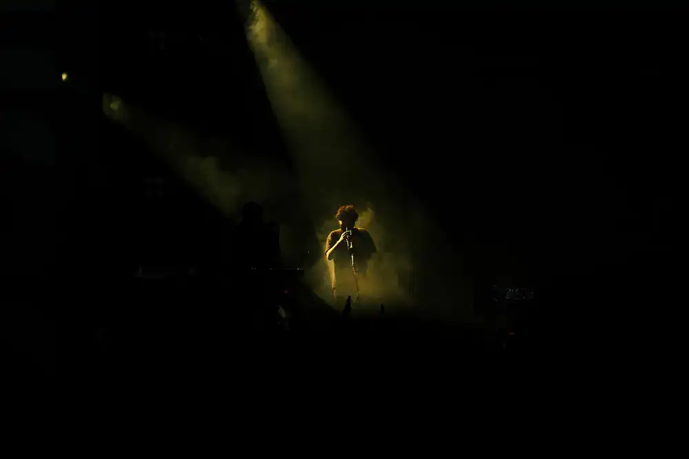 Players competing on the main stage under dramatic lighting
