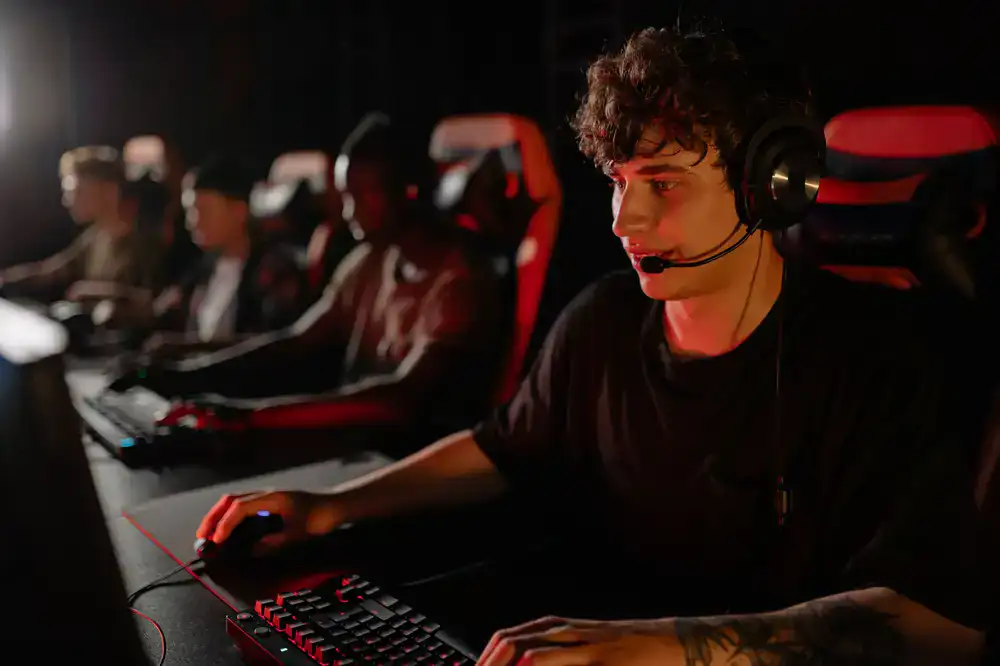 Fans cheering behind a row of high-end competitive gaming setups